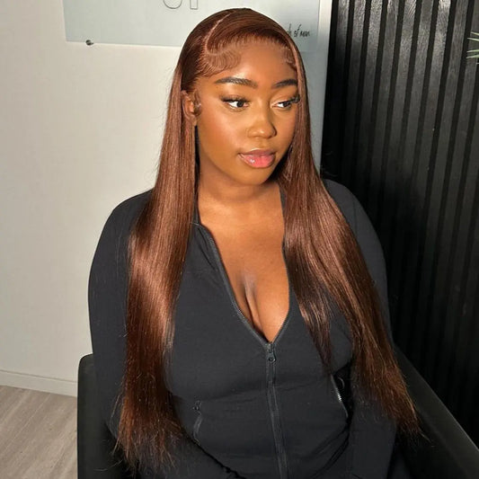 Woman with long brown hair wearing a black outfit in an indoor setting