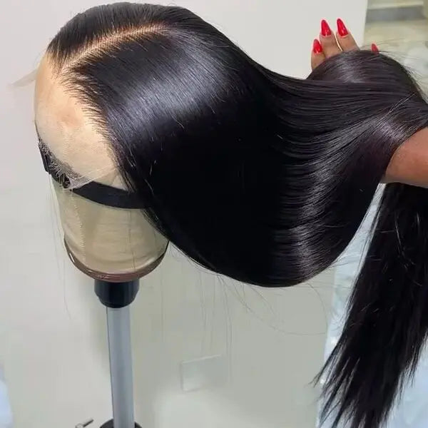 Black wig on a mannequin head with a plain background