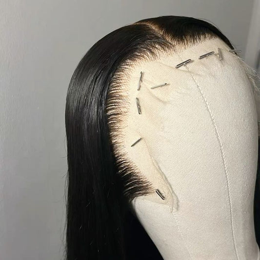Black lace front wig on a mannequin head against a plain background